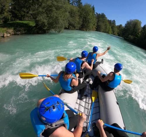 a group of people in a raft on a river at Apartments Karin in Bled