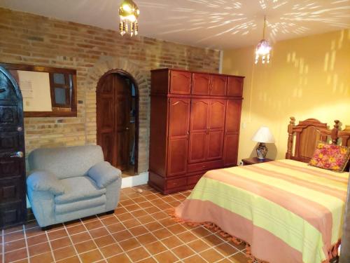 a bedroom with a bed and a chair and a dresser at HABITACIONES EN VALLARTA 6 CUADRAS MALECON in Puerto Vallarta