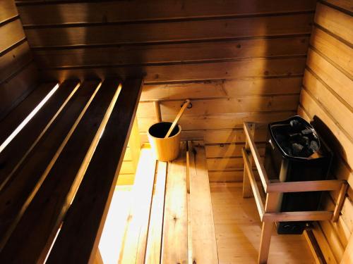 an inside view of a sauna with a bucket at Merejussi Puhkemajad in Pärna