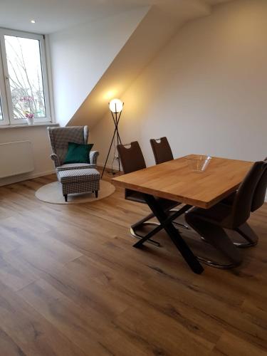 a dining room with a wooden table and chairs at Wolke 7 in Hattingen