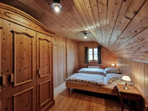 a bedroom with a bed and a wooden ceiling at Ferienhaus Rosl am Grundlsee in Grundlsee