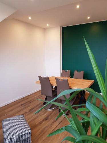 a conference room with a table and chairs and a plant at Wolke 7 in Hattingen