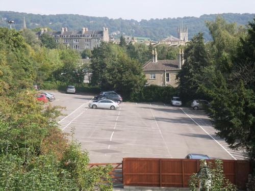 a parking lot with cars parked in it at Elgin Villa in Bath