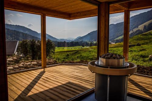 a screened in porch with a view of the mountains at Gästehaus Oben am Berg in Balderschwang