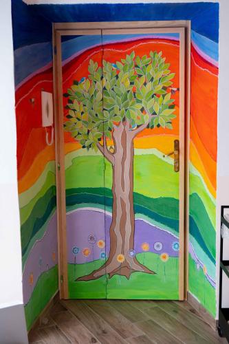a door with a tree painted on it at NOVECENTO b&b in Papasidero