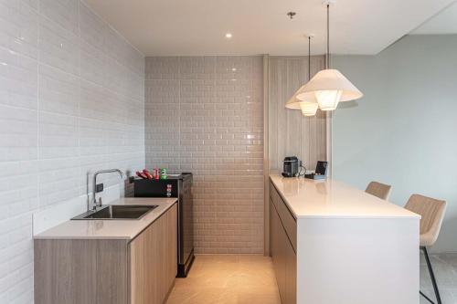 a kitchen with a sink and a counter top at Laguna Grand Hotel & Spa Songkhla in Songkhla