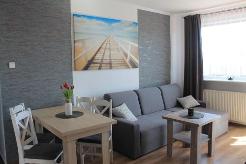 a living room with a couch and a table at Apartament "u Mamy" Władysławowo in Władysławowo
