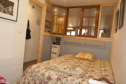 a small bedroom with a bed and a cabinet at Breil centre 2pces in Breil-sur-Roya