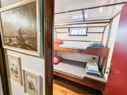 ハーレムにあるThe Cabin - Haarlemの小さなお部屋で、ボート上の二段ベッド1組が備わります。