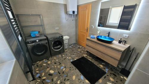 a bathroom with a washing machine and a washer at Apartment Lidija in Krk