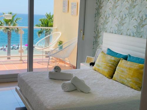 a bedroom with a bed with a view of the ocean at Avenida Sudamerica in Roquetas de Mar