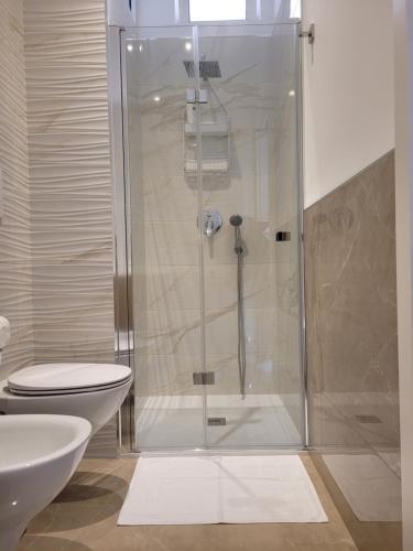 a bathroom with a shower with a toilet and a sink at viLAvì Casa Vacanze in Polignano a Mare