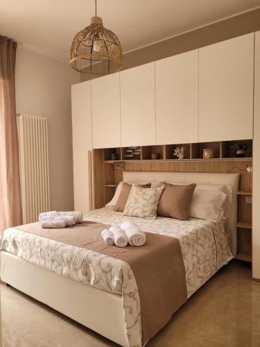 a bedroom with a large bed with towels on it at viLAvì Casa Vacanze in Polignano a Mare