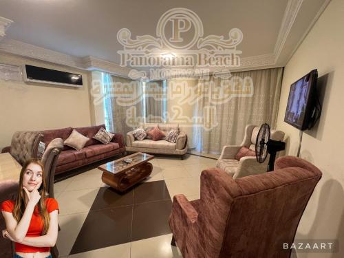 a woman is standing in a living room at شقق بانوراما شاطئ الأسكندرية كود 10 in Alexandria