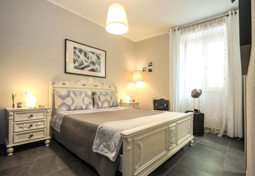 a bedroom with a large bed and a window at Musica Guest House in Alghero