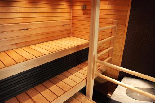 a small wooden sauna with a bench in it at Saimaanranta Resort by Anttolanhovi in Mikkeli