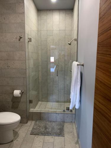 a bathroom with a shower and a toilet at El Refugio in Ensenada