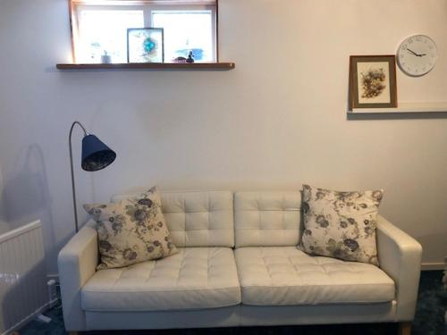 a white couch in a living room with a window at Österlen - Skillinge in Skillinge