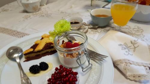 a plate of food with a dessert on a table at Musica Guest House in Alghero