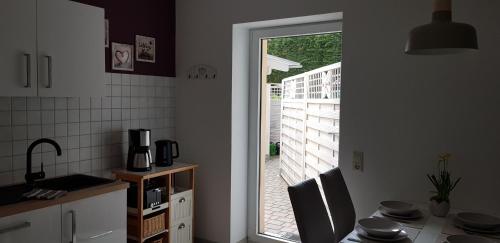 a kitchen with a door leading to a patio at Ferienwohnung Happy in Tangermünde