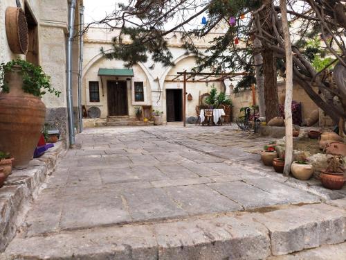 a courtyard of a building with potted plants at ARMEsos Cave Hotel in Urgup