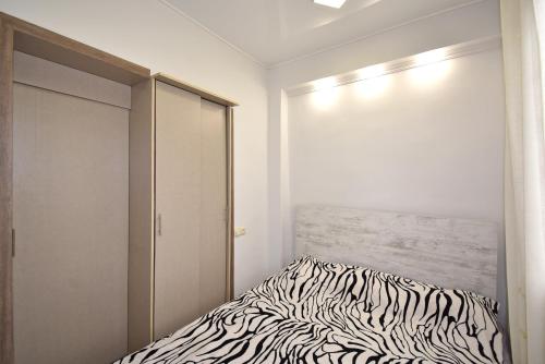 a bedroom with a zebra print bed and a closet at 7/1Exellent apartment in the center of the capital in Yerevan