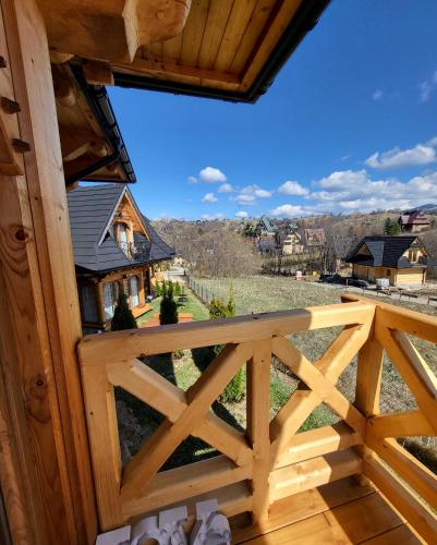 a view from the balcony of a log cabin at Góralska Chatka 3 Highland Cottage - Jacuzzi, Sauna, Split AC, Private parking, Mountains View in Zakopane