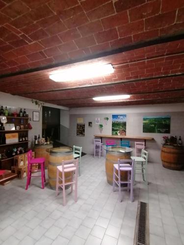 a room with tables and chairs and a bar at La Bella Vite in Moncalvo
