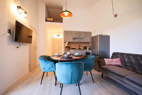 sala de estar con mesa, sillas y sofá en Apartments Marta en Verunić