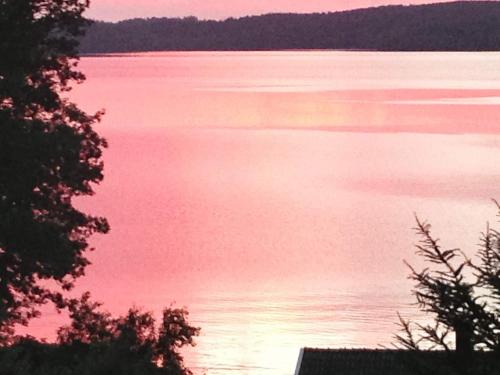 a view of a body of water at sunset at 7 person holiday home in ALLINGSÅS, SVERIGE in Hjälmared