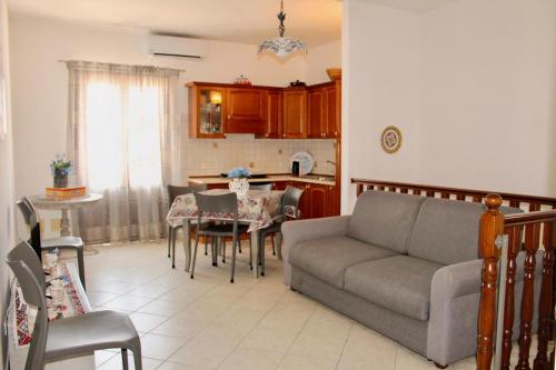 a living room with a couch and a table at Desy Appartamenti in San Vito lo Capo