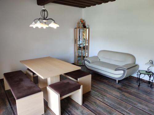 a living room with a table and a chair at Ferienhof Unterführholzergut in Klaus