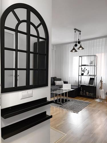 a living room with a large mirror on the wall at Pristina City Apartment in Pristina