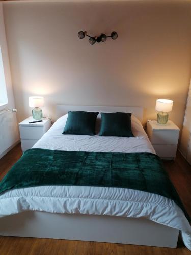 a bedroom with a large bed with two night stands at La maison d'Hôtes Du Moulin in Lagardelle-sur-Lèze