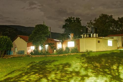 a house on a grassy hill at night at Casa de Campo, Excelente Ubicación y Amplias Zonas Verdes in Sogamoso