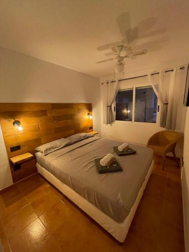 a bedroom with a large bed and a window at Los Nietos Apartment in Los Nietos