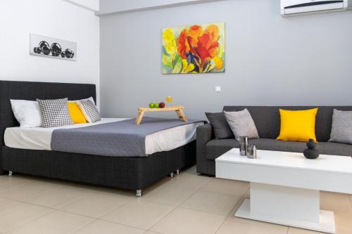 a bedroom with a bed and a couch at C3 Modern Spartan Apartment in Sparti