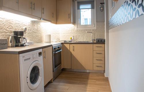 eine Küche mit einer Waschmaschine und einer Waschmaschine in der Unterkunft Maria's Home in Athen