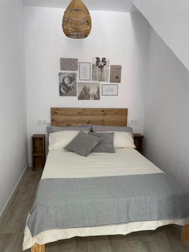 a bedroom with a large bed in a white room at Apartamento Tarifa Sunset in Tarifa