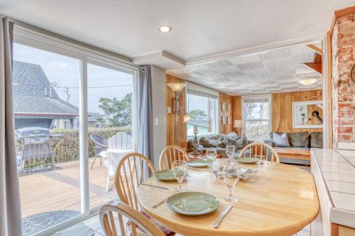 a kitchen and dining room with a wooden table and chairs at By The Sea in Lincoln City