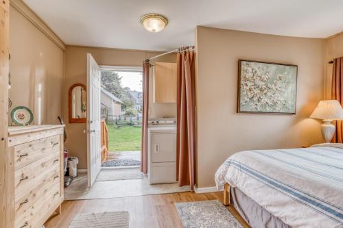 a bedroom with a bed and a door to a yard at By The Sea in Lincoln City