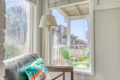 a living room with a window with a couch and a lamp at Surf Shack in Lincoln City