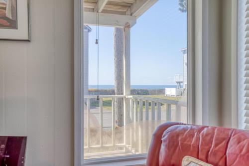 a room with a large window looking out at the ocean at Surf Shack in Lincoln City