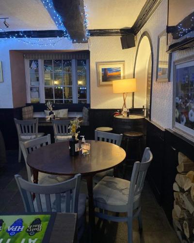 a dining room with a table and chairs at The Castle Inn in Usk