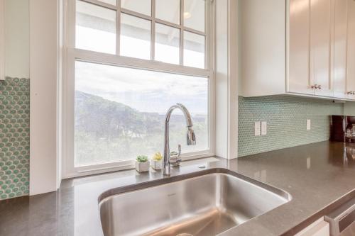 a kitchen with a sink and a window at The Driftwood in Depoe Bay