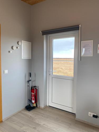 an empty room with a door with a window at Uxahryggur in Hvolsvöllur