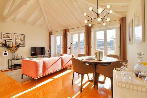 a dining room and living room with a table and chairs at Wonderful Porto Design Apartments in Porto