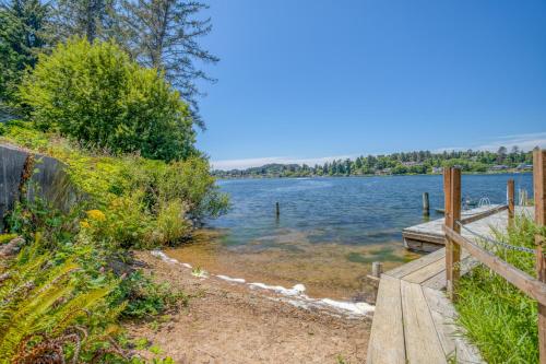a path next to a lake with a wooden dock at Laurel Haven - Meredith Lodging in Otis