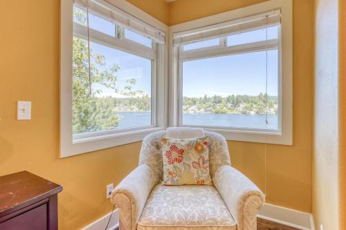 a chair sitting in a room with two windows at Laurel Haven - Meredith Lodging in Otis
