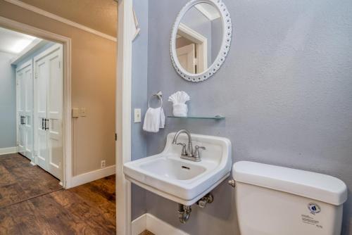 a bathroom with a sink and a mirror and a toilet at Laurel Haven - Meredith Lodging in Otis